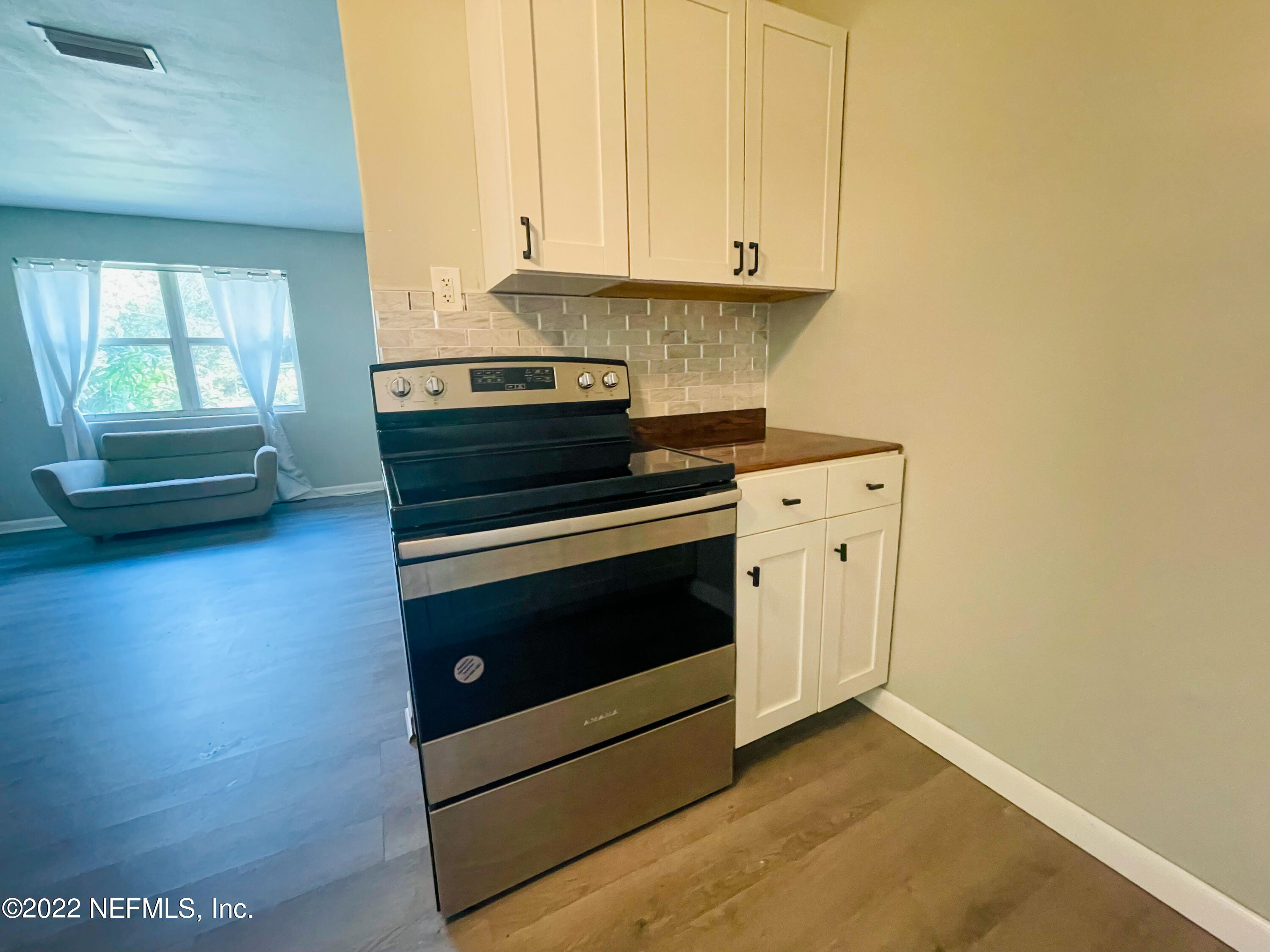 3151 Brasque Drive Jacksonville, FL 32209 - Photo 7 of 18 a kitchen with a stove and a microwave