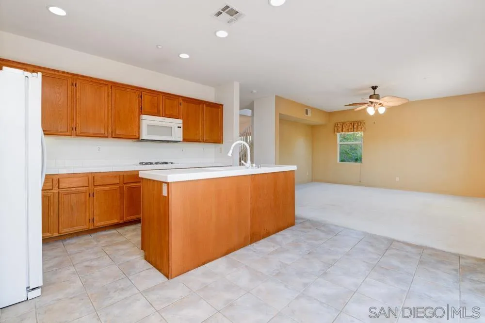 344 Natalie Way Fallbrook, CA 92028 - Photo 14 of 37 a kitchen with stainless steel appliances granite countertop a sink a stove top oven and cabinets