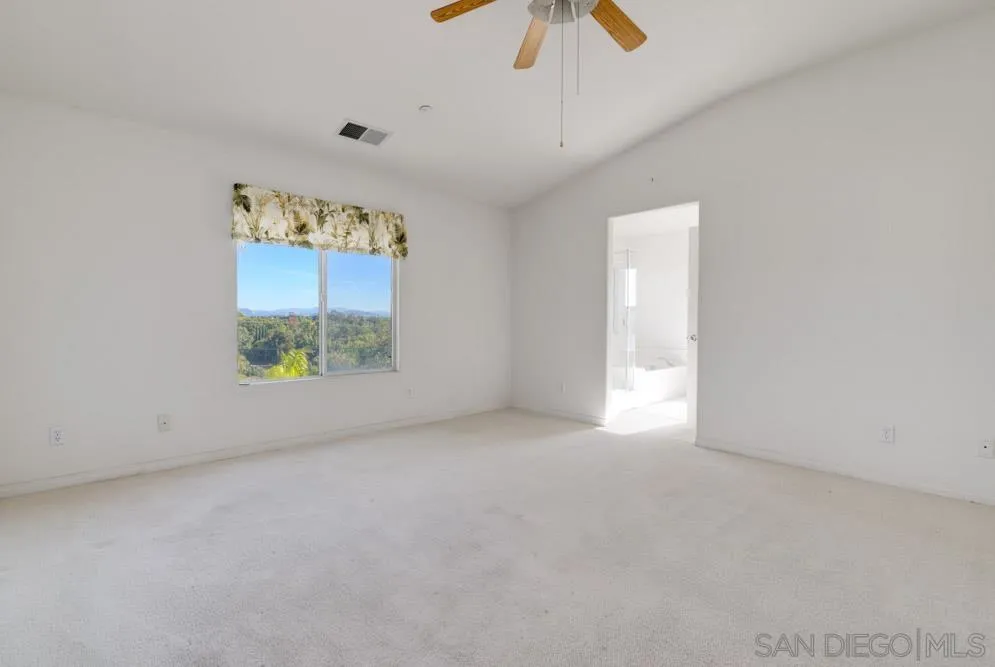 344 Natalie Way Fallbrook, CA 92028 - Photo 26 of 37 an empty room with windows and chandelier fan