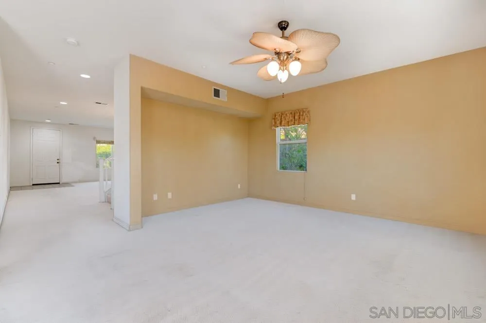 344 Natalie Way Fallbrook, CA 92028 - Photo 9 of 37 an empty room with a chandelier fan and a chandelier fan