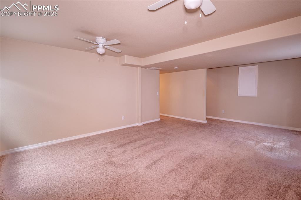 7313 Owings Point Peyton, CO 80831 - Photo 18 of 47 Spare room featuring a ceiling fan and light colored carpet