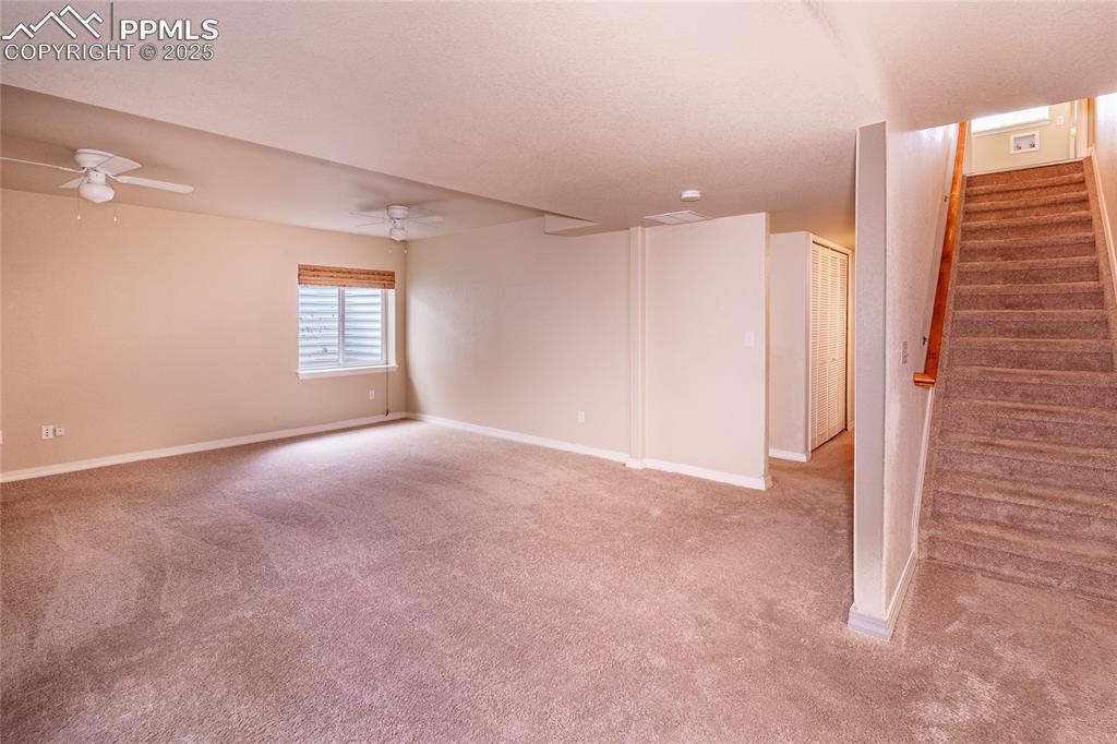 7313 Owings Point Peyton, CO 80831 - Photo 20 of 47 Basement featuring stairs and light carpet