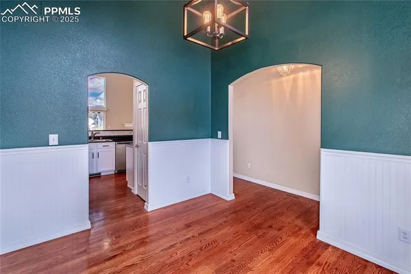 a kitchen with granite countertop a sink stove and microwave