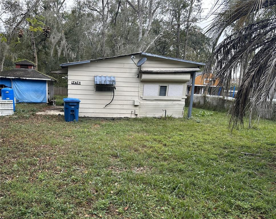 17479 Tavern Road Brooksville, FL 34604 - Photo 8 of 10 a front view of a house with garden