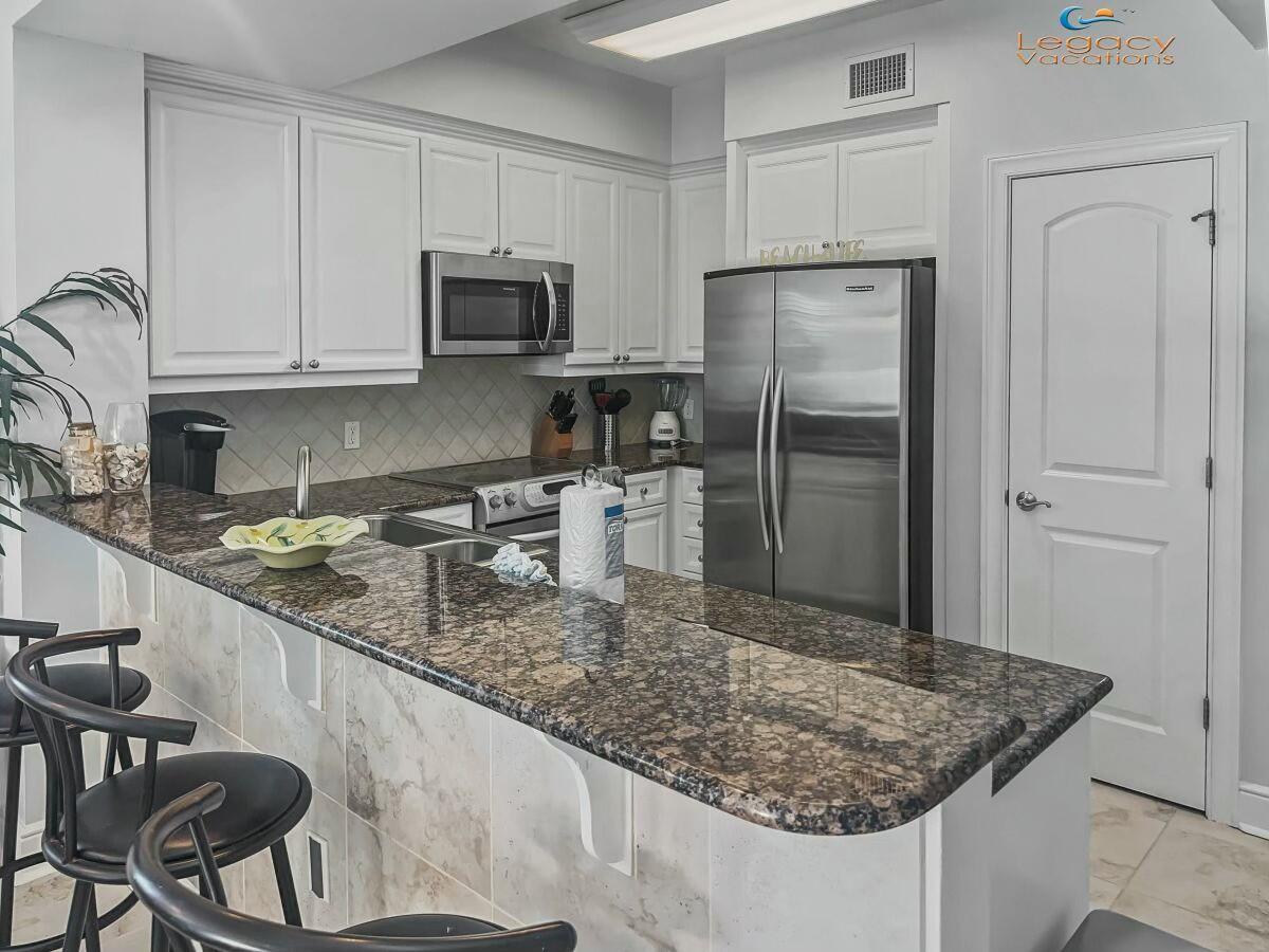 1150 Santa Rosa Boulevard, Unit 223 Fort Walton Beach, FL 32548 - Photo 11 of 53 a kitchen with stainless steel appliances granite countertop a sink stove and refrigerator