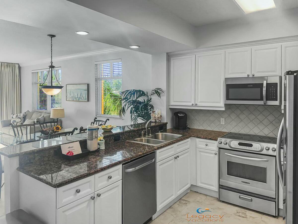 1150 Santa Rosa Boulevard, Unit 223 Fort Walton Beach, FL 32548 - Photo 12 of 53 a kitchen with stainless steel appliances granite countertop a sink a stove and cabinets