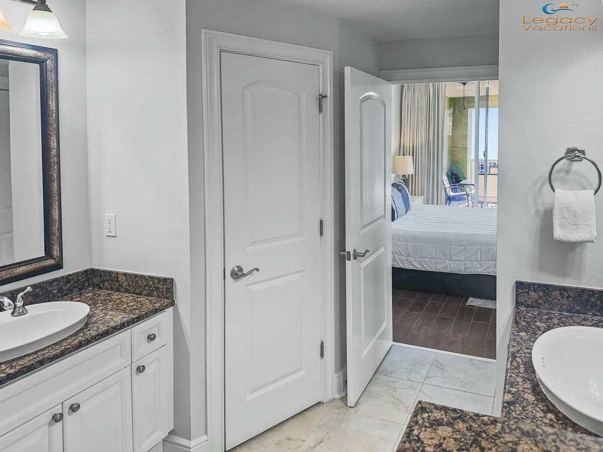 1150 Santa Rosa Boulevard, Unit 223 Fort Walton Beach, FL 32548 - Photo 20 of 53 a en suite bathroom with a granite countertop sink and a mirror
