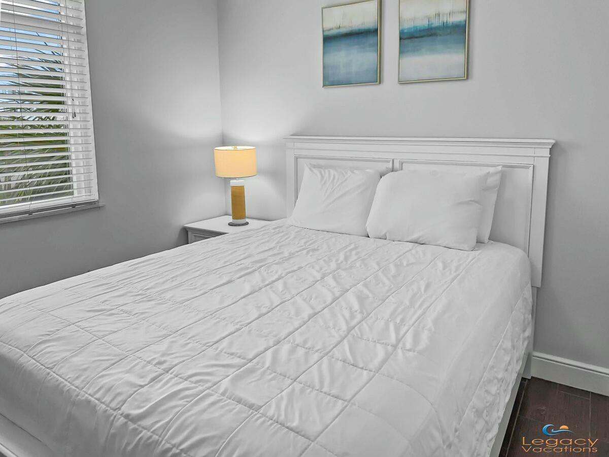 1150 Santa Rosa Boulevard, Unit 223 Fort Walton Beach, FL 32548 - Photo 21 of 53 a large white bed in a bedroom next to a window