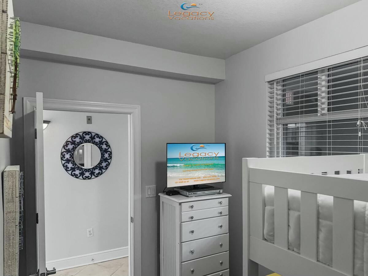 1150 Santa Rosa Boulevard, Unit 223 Fort Walton Beach, FL 32548 - Photo 25 of 53 a front view of a bedroom with a baby crib and a dresser