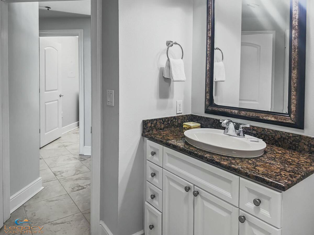 1150 Santa Rosa Boulevard, Unit 223 Fort Walton Beach, FL 32548 - Photo 26 of 53 a bathroom with a granite countertop sink and a mirror