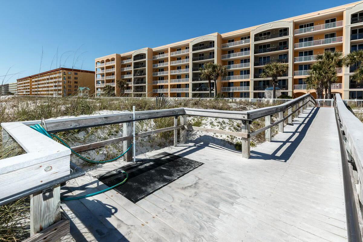 1150 Santa Rosa Boulevard, Unit 223 Fort Walton Beach, FL 32548 - Photo 46 of 53 a view of a balcony with wooden fence and two windows
