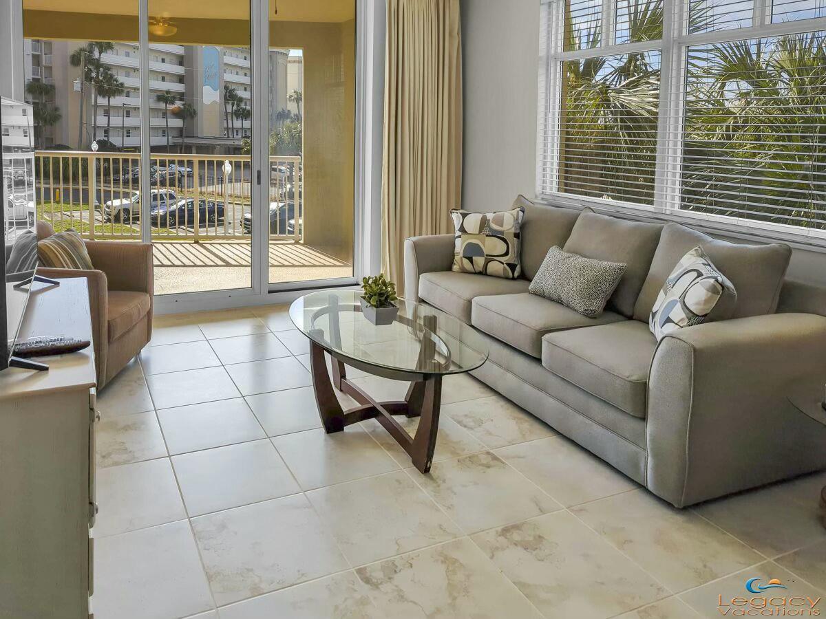 1150 Santa Rosa Boulevard, Unit 223 Fort Walton Beach, FL 32548 - Photo 6 of 53 a living room with furniture and a floor to ceiling window
