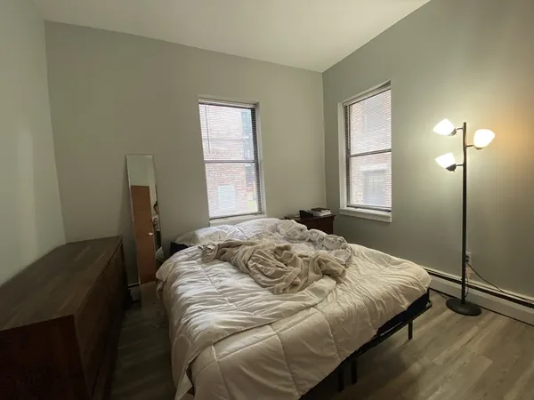 a bedroom with a bed and a window