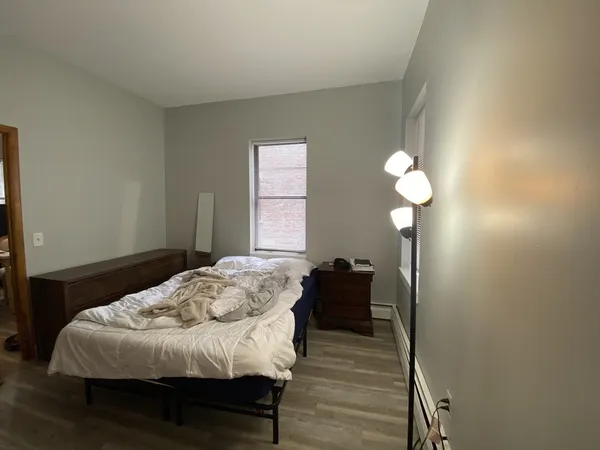 a bedroom with a bed and a chandelier