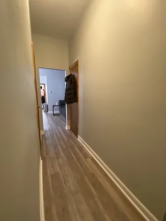 a view of a room with wooden floor