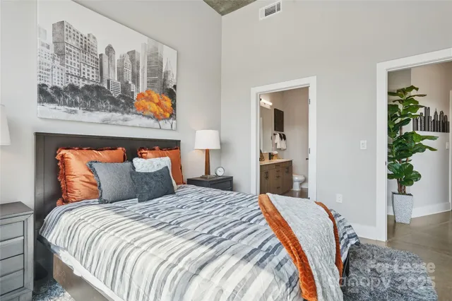a bedroom with bed and wooden floor