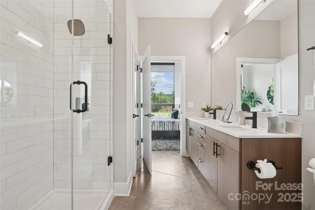 a bathroom with a double vanity sink and shower