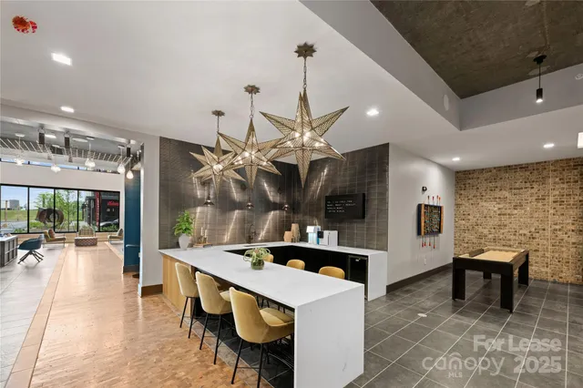 a kitchen with stainless steel appliances kitchen island granite countertop a sink and a refrigerator