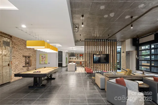 a living room with fireplace furniture and a large window