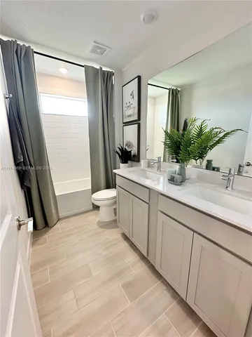 a utility room with a sink dryer and washer