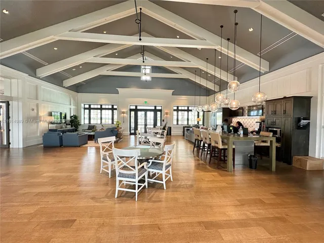 a living room with furniture a chandelier and a table