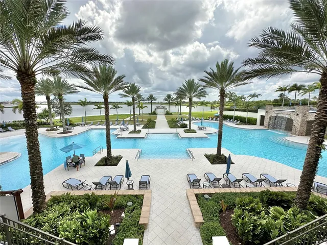 a view of swimming pool with outdoor seating and lake