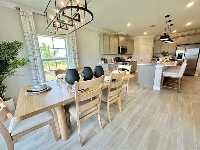a view of a dining room with furniture window and outside view