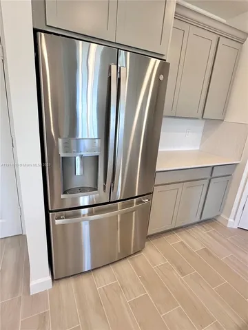 a view of a refrigerator in a kitchen