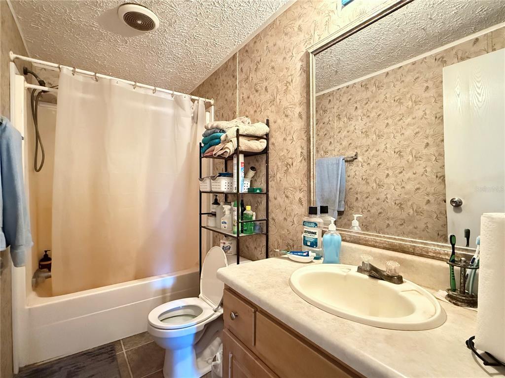 11101 Sumner Road Wimauma, FL 33598 - Photo 20 of 22 a bathroom with a sink toilet mirror and shower