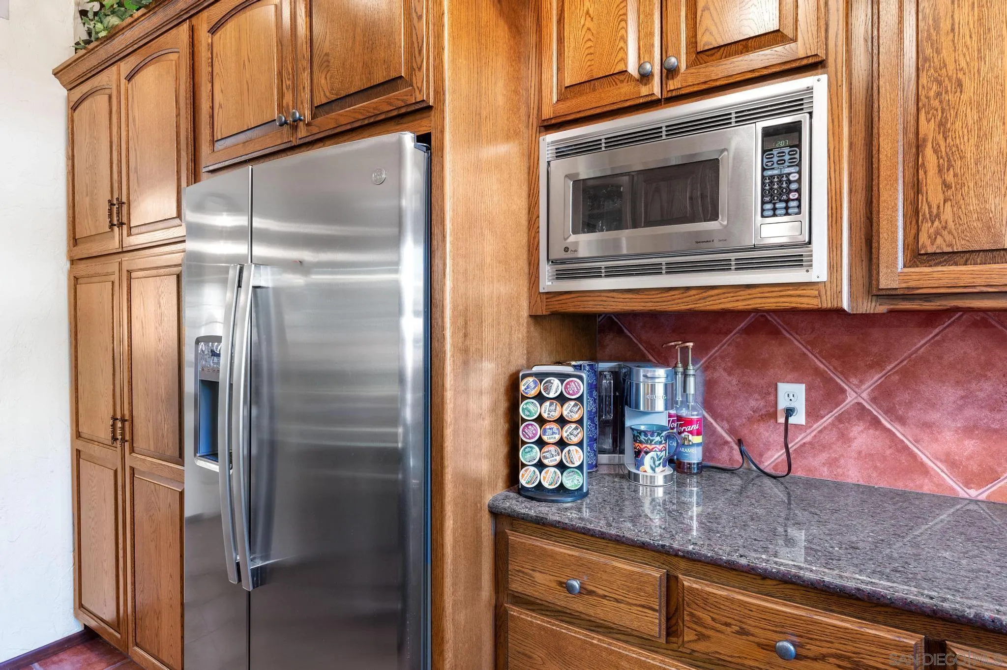 24572 Rutherford Road Ramona, CA 92065 - Photo 32 of 62 a kitchen with stainless steel appliances granite countertop a refrigerator and cabinets