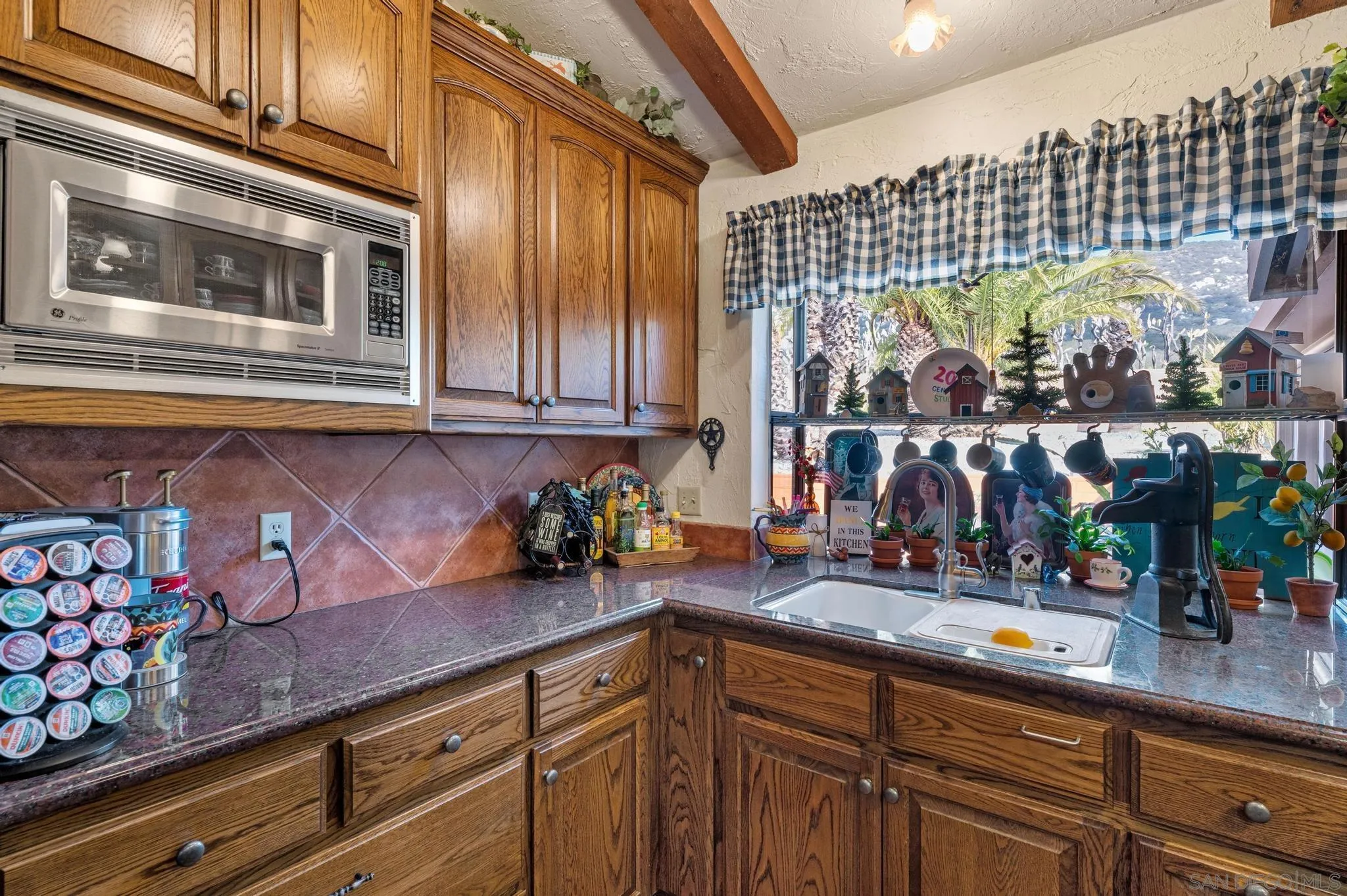 24572 Rutherford Road Ramona, CA 92065 - Photo 33 of 62 a kitchen with lots of counter top space and wooden floor