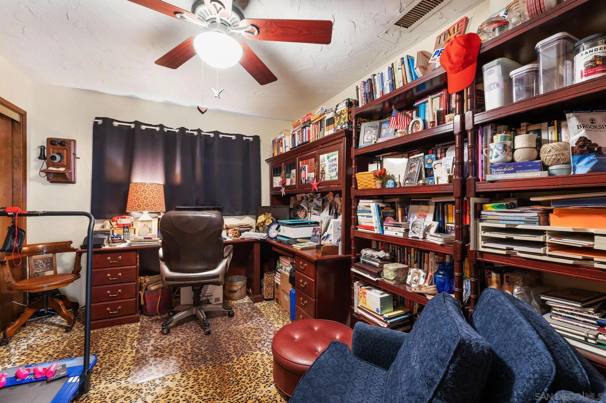24572 Rutherford Road Ramona, CA 92065 - Photo 39 of 62 a living room with furniture a bookshelf and a book shelf