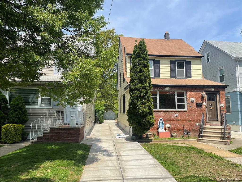 248-29 88th Road Queens, NY 11426 - Photo 20 of 21 a front view of a house with a yard