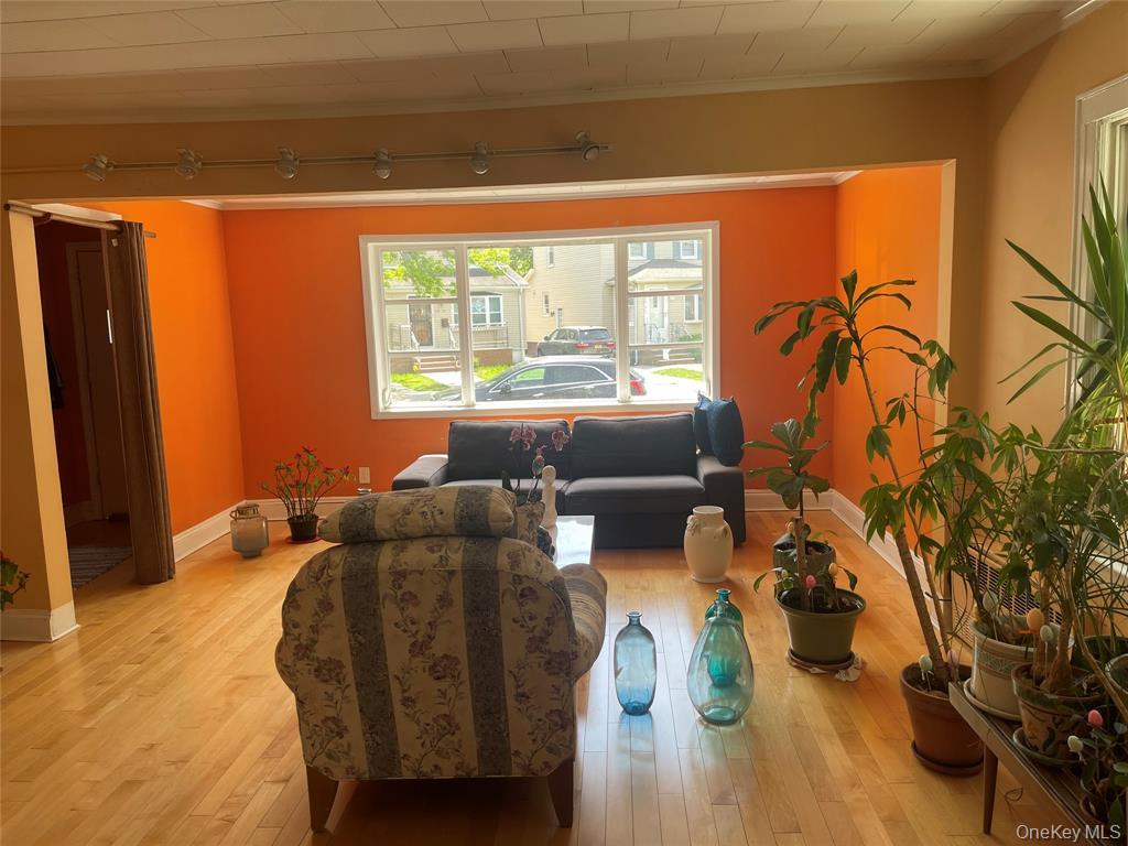 248-29 88th Road Queens, NY 11426 - Photo 3 of 21 a living room with furniture and a large window