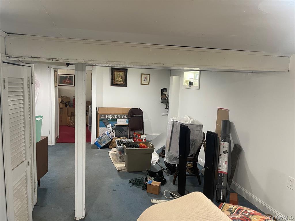 248-29 88th Road Queens, NY 11426 - Photo 9 of 20 a bathroom with a toilet a sink and mirror