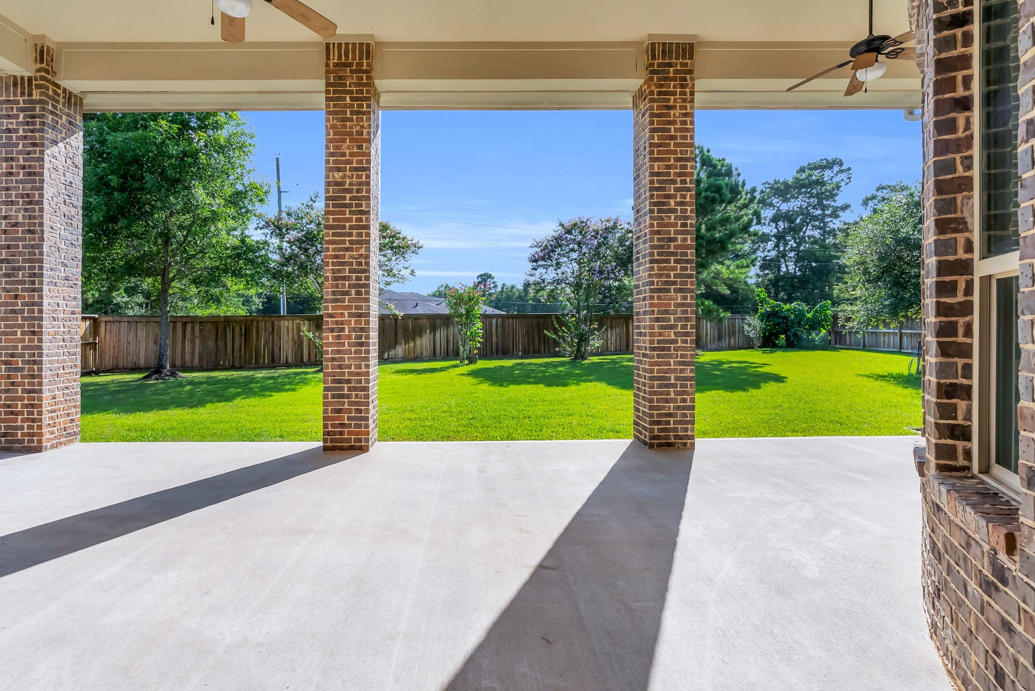 4022 Sabine Valley Trail Spring, TX 77386 - Photo 33 of 46 Enjoy outdoor living on this spacious, covered patio with brick columns. Fully open to a lush, fenced backyard, perfect for outdoor gatherings and relaxation.