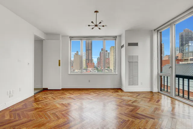 a dining room with furniture large windows and wooden floor