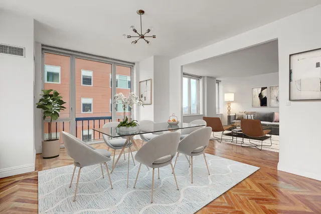 a view of an empty room with window and hardwood floor