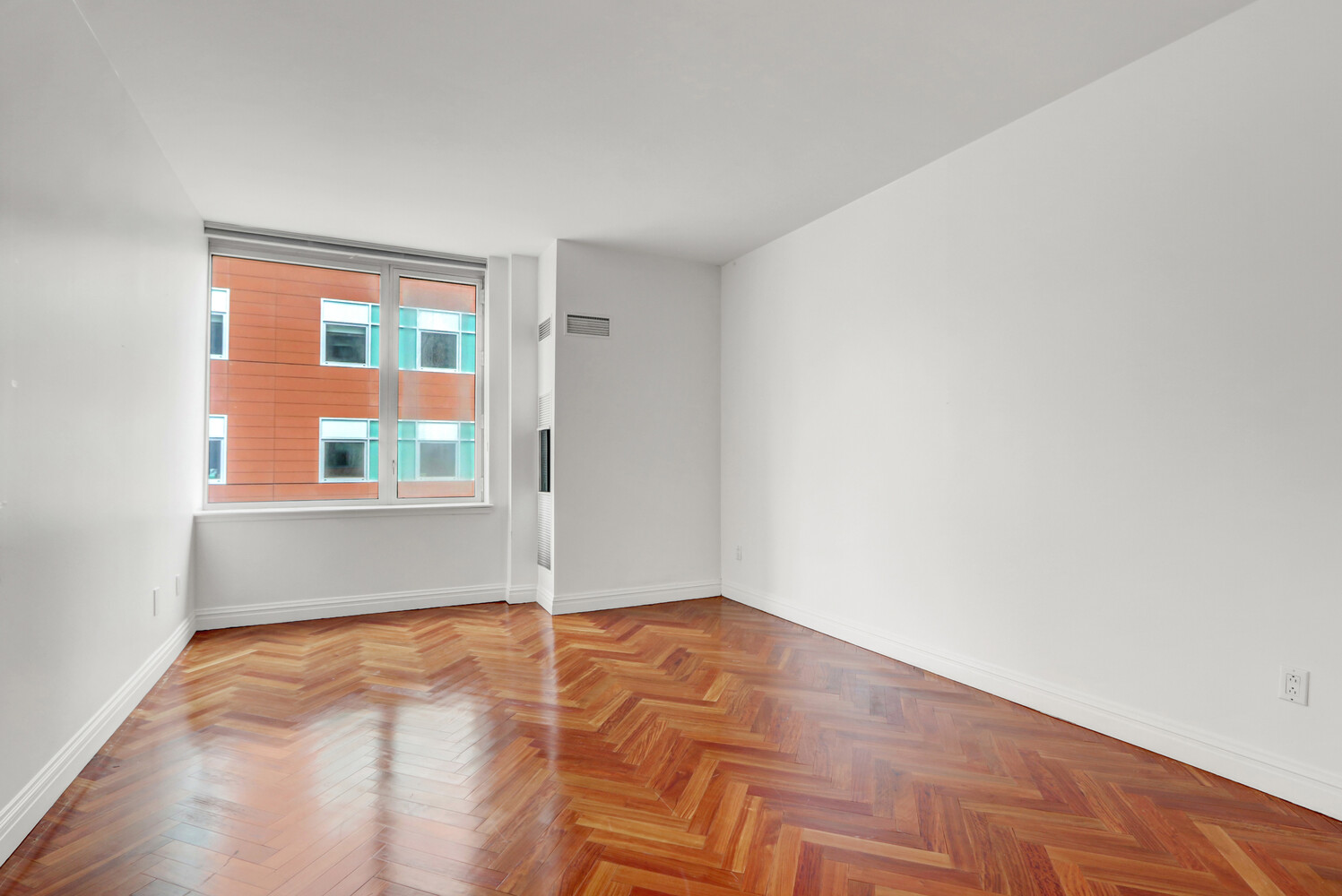 90 East End Avenue, Unit 10B Manhattan, NY 10028 - Photo 16 of 39 a view of an empty room with wooden floor and a window
