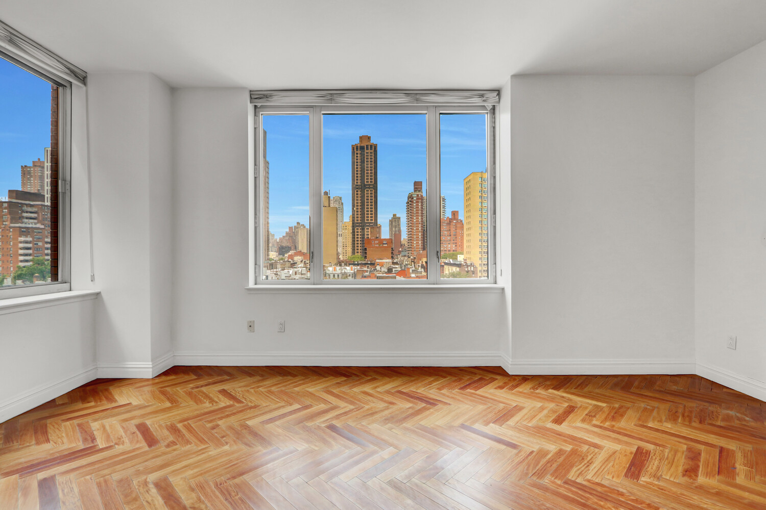 90 East End Avenue, Unit 10B Manhattan, NY 10028 - Photo 25 of 39 a view of an empty room with wooden floor and a window