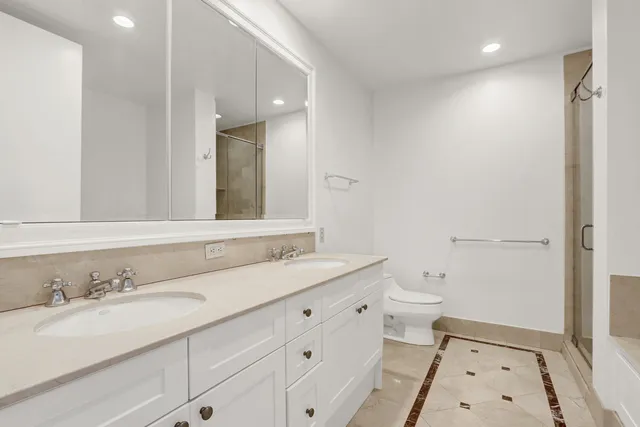 a bathroom with a double vanity sink mirror and