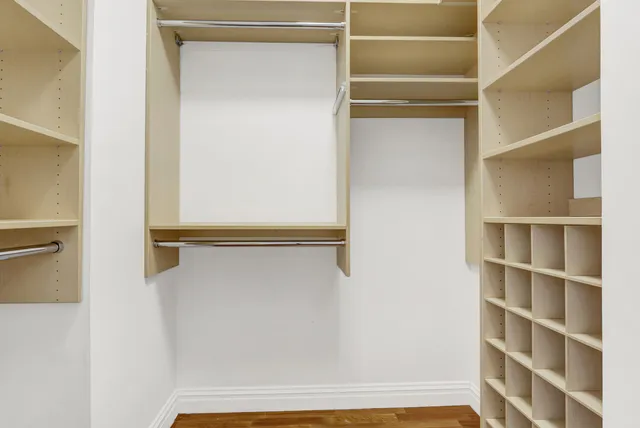 a view of walk in closet with empty racks