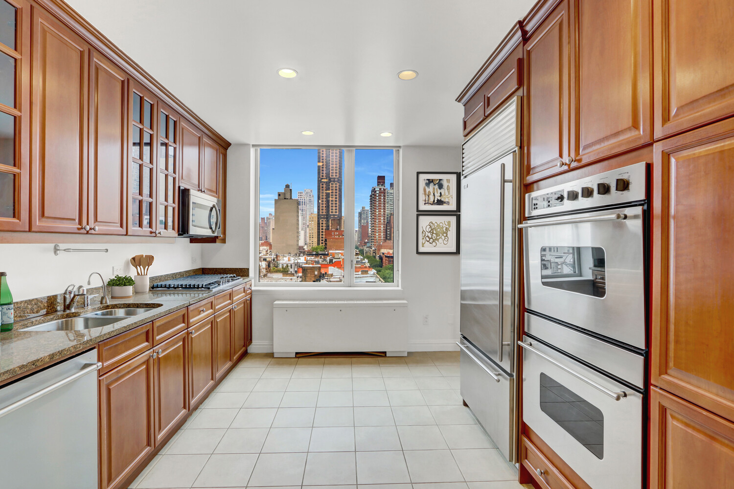 90 East End Avenue, Unit 10B Manhattan, NY 10028 - Photo 32 of 39 a kitchen with stainless steel appliances granite countertop a refrigerator and a sink
