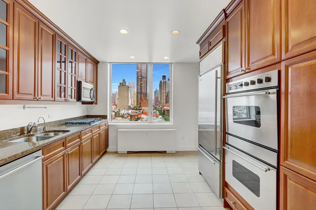 a kitchen with stainless steel appliances granite countertop a refrigerator and a sink