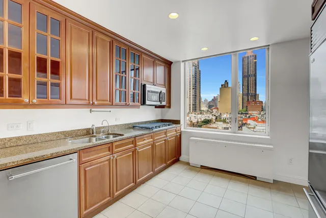 a kitchen with stainless steel appliances granite countertop a refrigerator and a sink