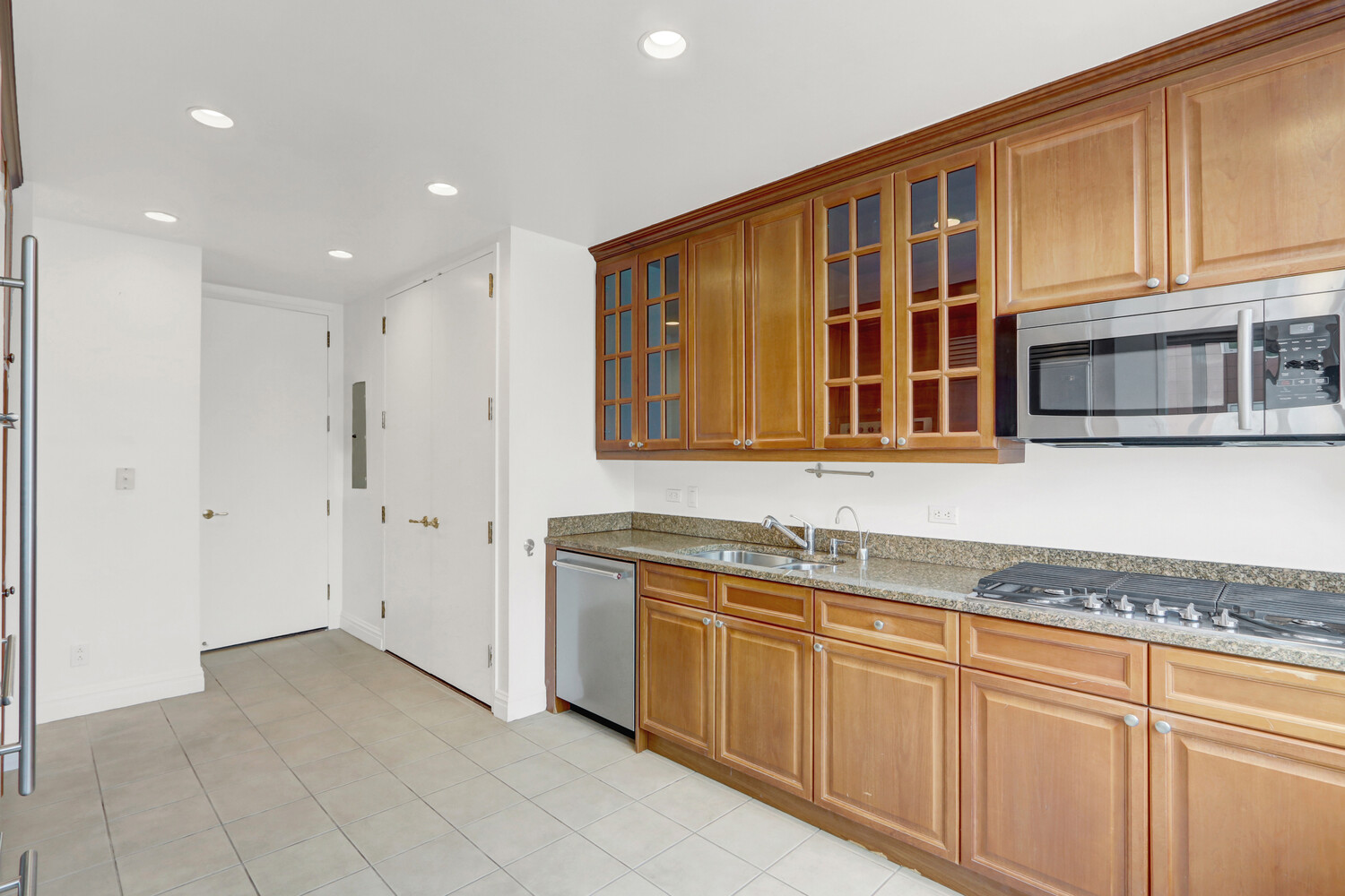 90 East End Avenue, Unit 10B Manhattan, NY 10028 - Photo 36 of 39 a kitchen with stainless steel appliances granite countertop a refrigerator and cabinets