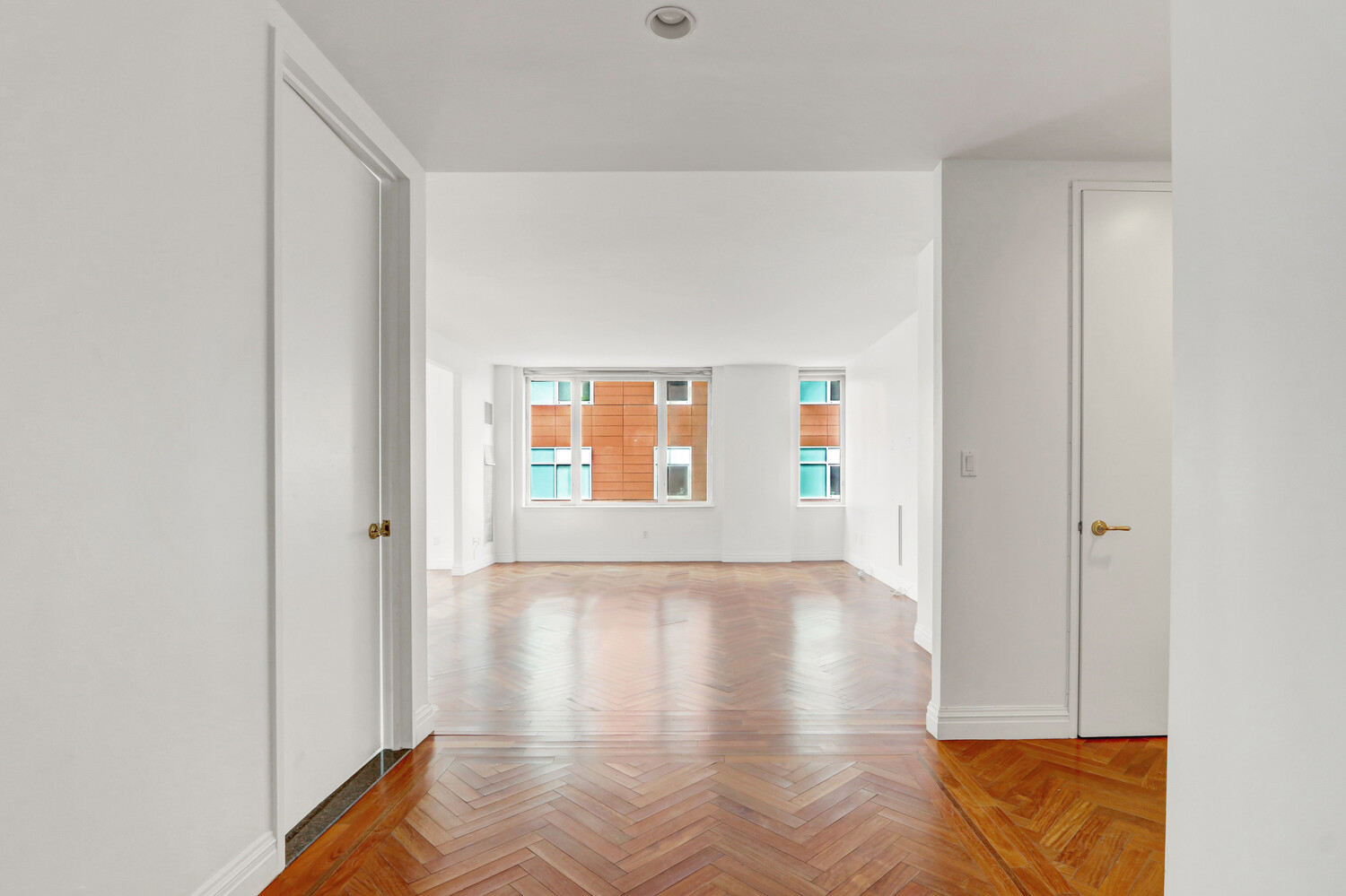 90 East End Avenue, Unit 10B Manhattan, NY 10028 - Photo 4 of 39 a view of an empty room with wooden floor and a window