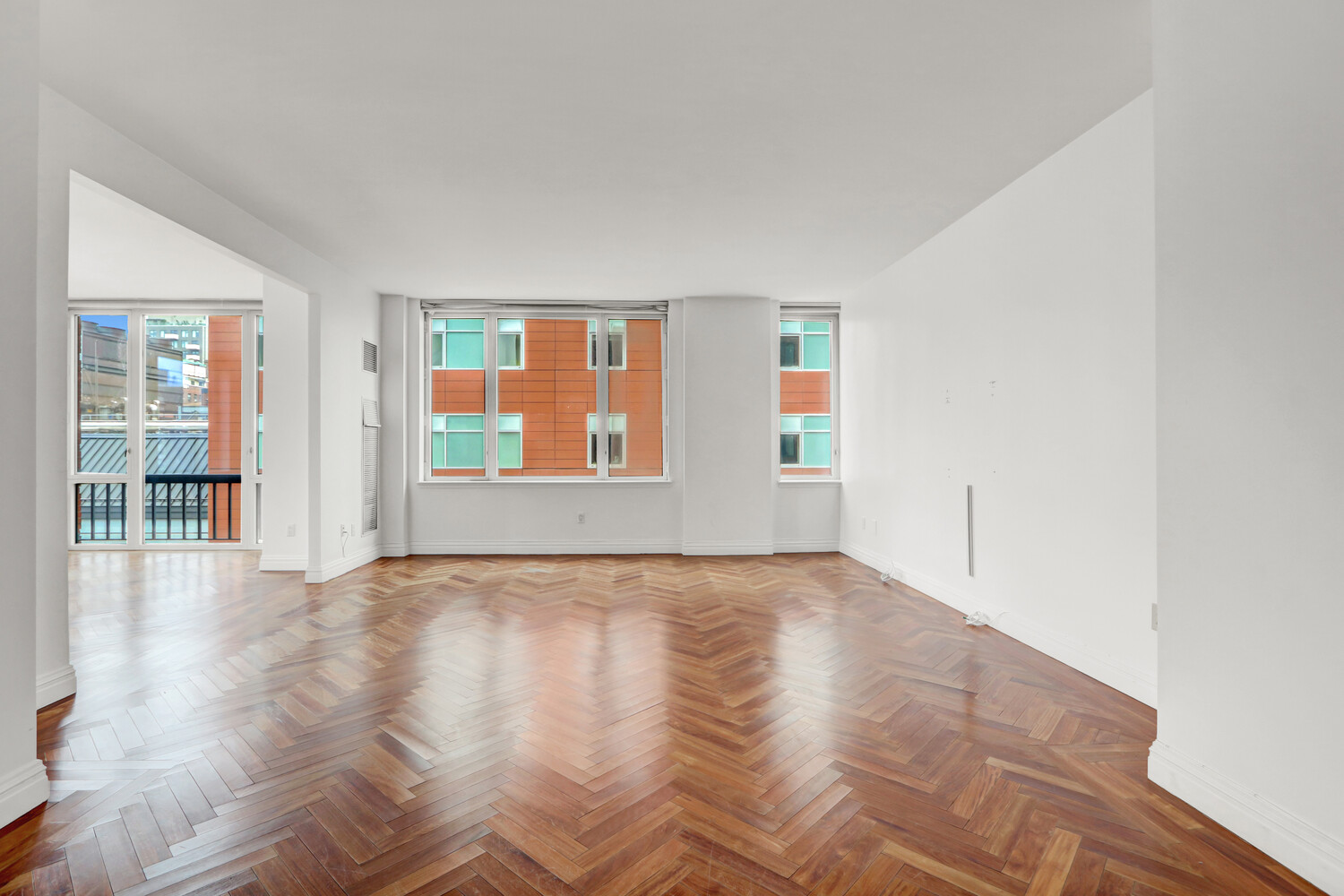 90 East End Avenue, Unit 10B Manhattan, NY 10028 - Photo 6 of 39 a view of an empty room with wooden floor and a window