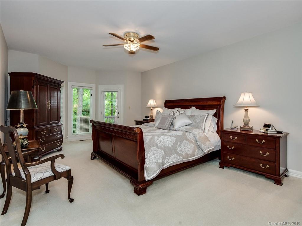 5123 Randolph Road Charlotte, NC 28211 - Photo 13 of 28 a bedroom with a bed and a chandelier
