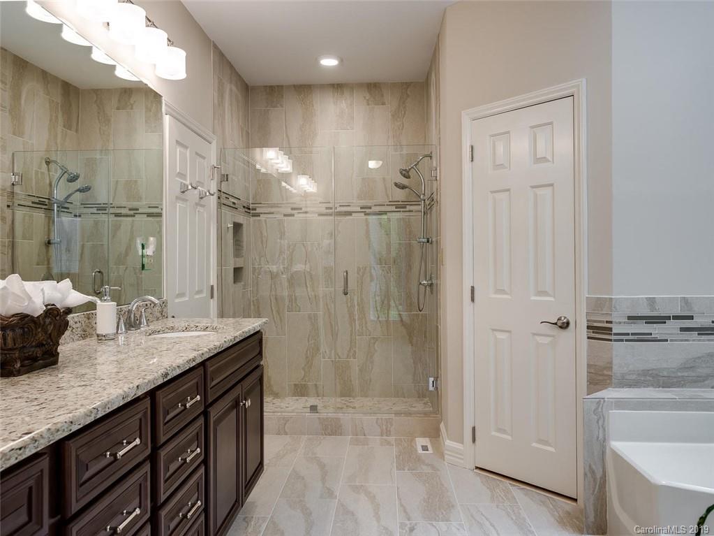 5123 Randolph Road Charlotte, NC 28211 - Photo 14 of 28 a bathroom with a granite countertop sink a shower and a mirror